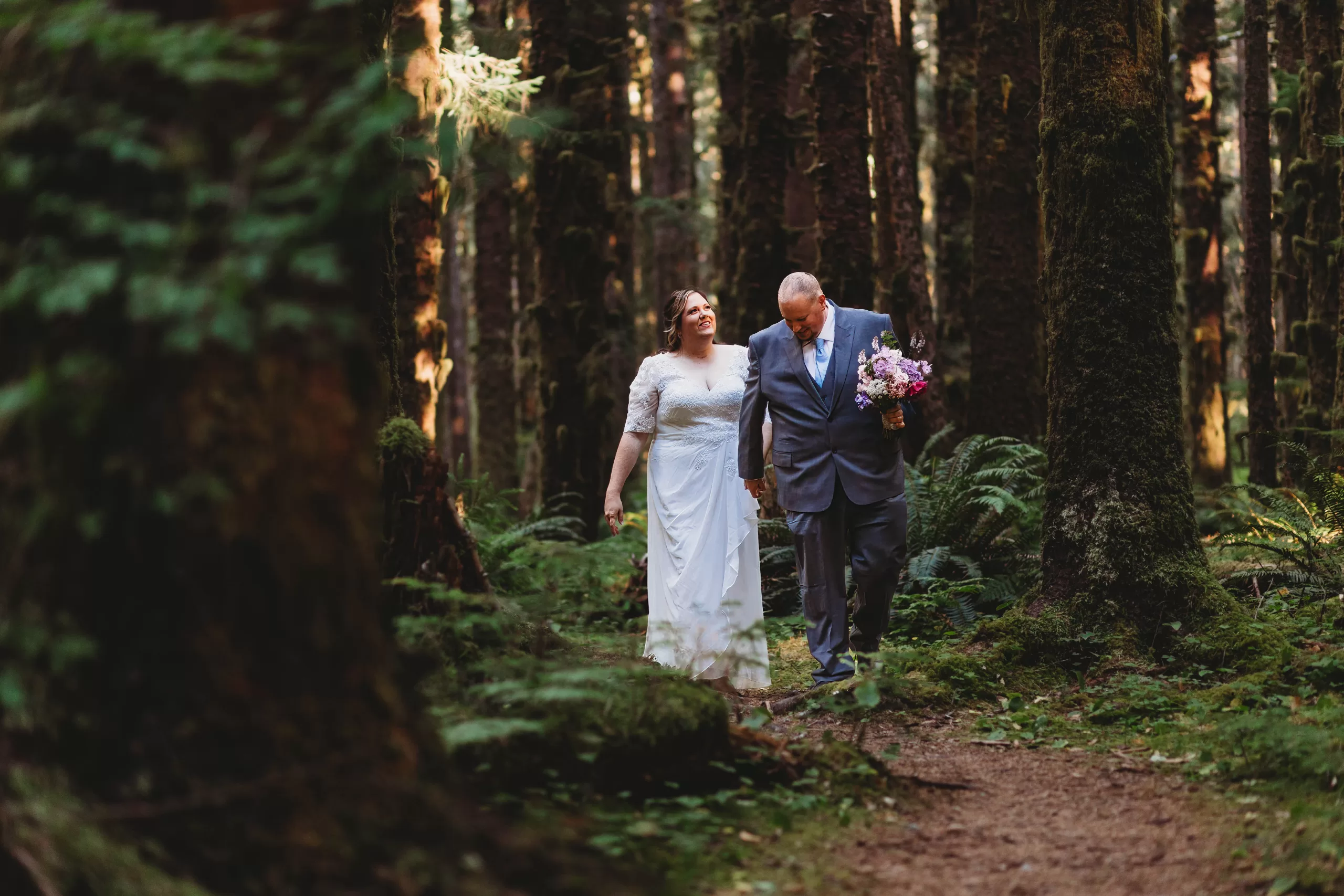 Golden hour elopement photo of bride & groom near Hoh Rainforest inside of Olympic National Park