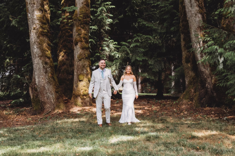 Bride and groom walking through the trees and enjoying a private moment before their wedding ceremony at Larkin Place in Olympia, WA