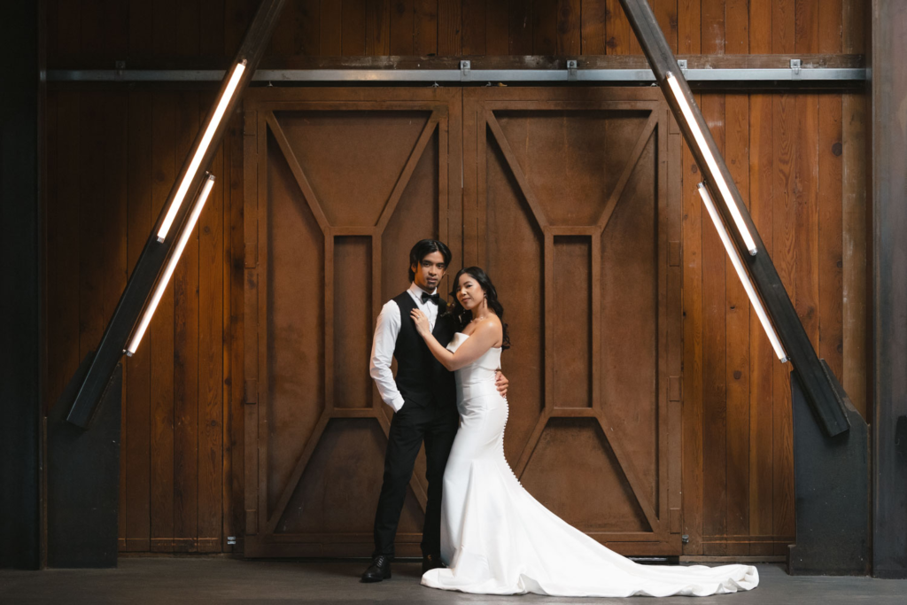 Bride and groom portrait in front of industrial metal doors at WithinSODO in Seattle