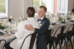 A couple celebrating at their Seattle wedding reception at The Point at Pier 70