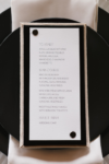 Elegant cloth wedding menu card for a Seattle Architectural Romance luxury wedding celebration featuring metal posts and fabric details