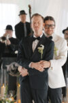 Groom's embracing during their first dance at their Seattle wedding reception at The Point at Pier 70 in Seattle