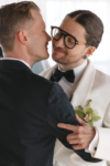 Grooms sharing an intimate moment during their first dance in Seattle at their wedding celebration at the Point at Pier 70 in Seattle