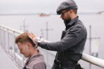 Barber styling groom on the balcony overlooking the Point at Pier 70's view of Puget Sound