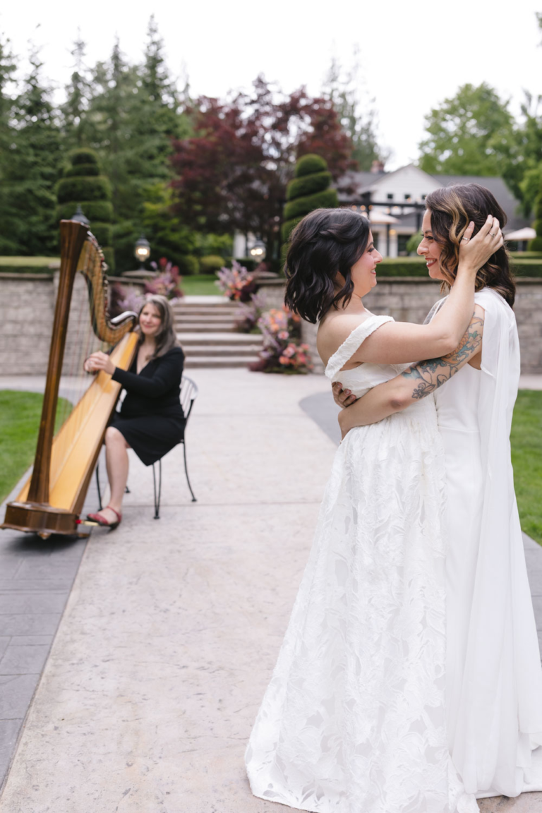 Newly weds share an intimate first dance on the walkway at Rock Creek Gardens with a harpist in the background