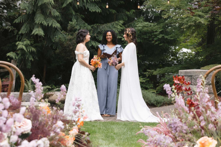 Two brides exchange vows on the lawns of Rock Creek Gardens for their wedding ceremony