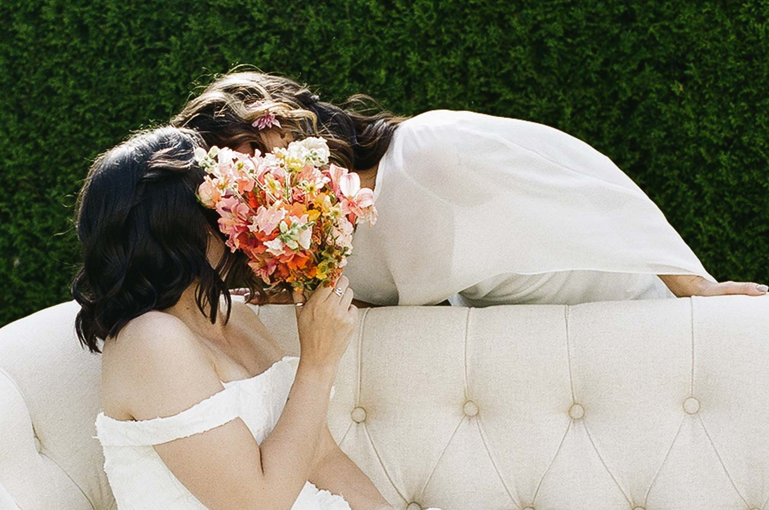 Two brides share a private kiss behind the bouquet at Rock Creek Gardens in Puyallup, WA captured on 35mm film.